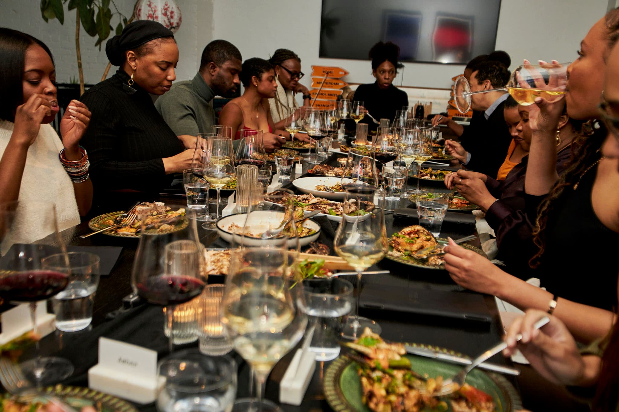 Lively dinner with guests sharing food and wine